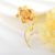Arannyal bevont exkluzív virágszál bross pezsgőszínű Swarovski kristályokkal (0687.)